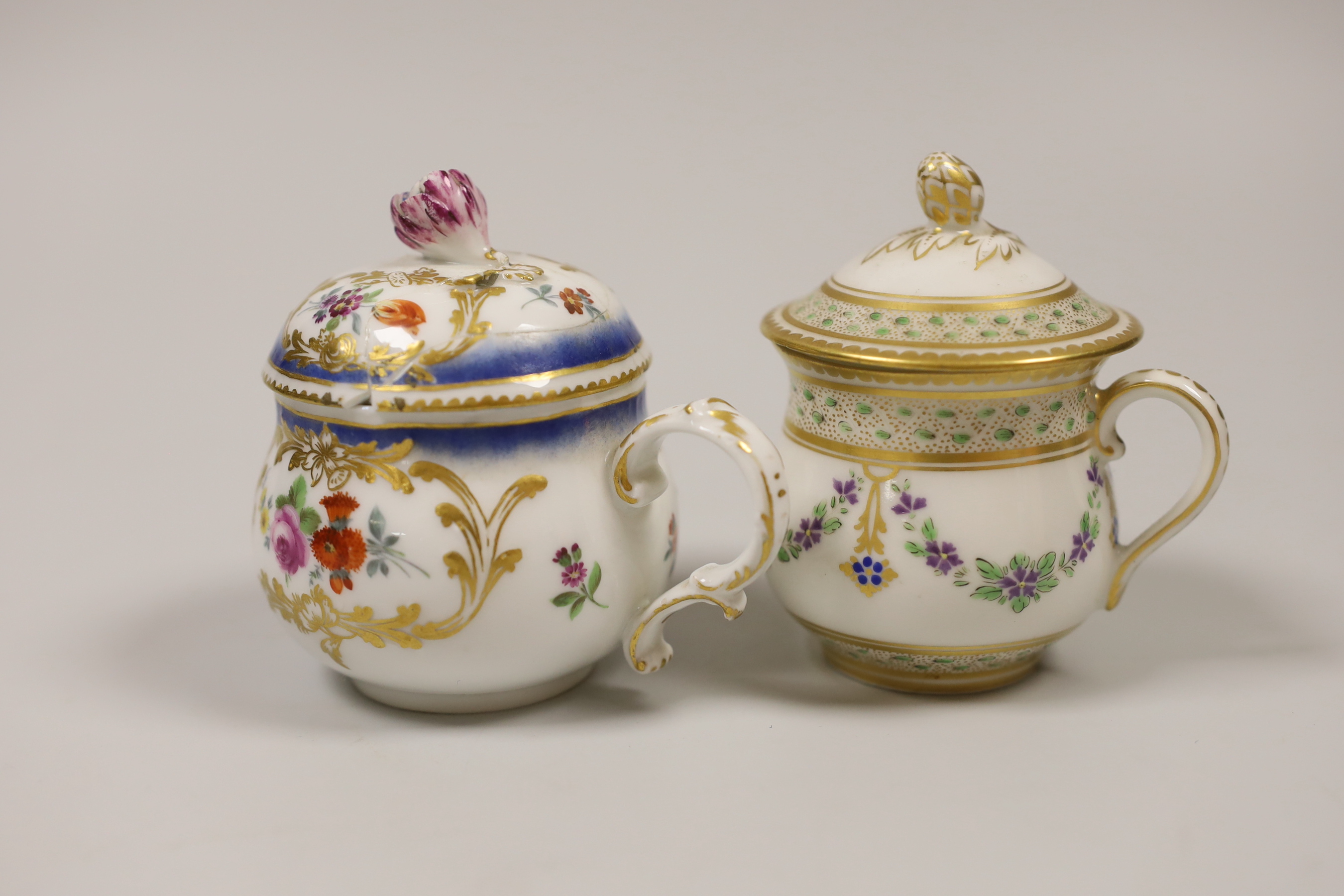 An 18th century Meissen custard cup and cover painted with flowers in Sevres style, crossed swords dot in blue, and a 19th century Paris porcelain custard cup and cover painted with chains of flowers, the largest 9cm hig
